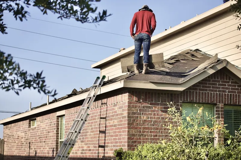Professional roofer working on a residential roof in Todd Creek